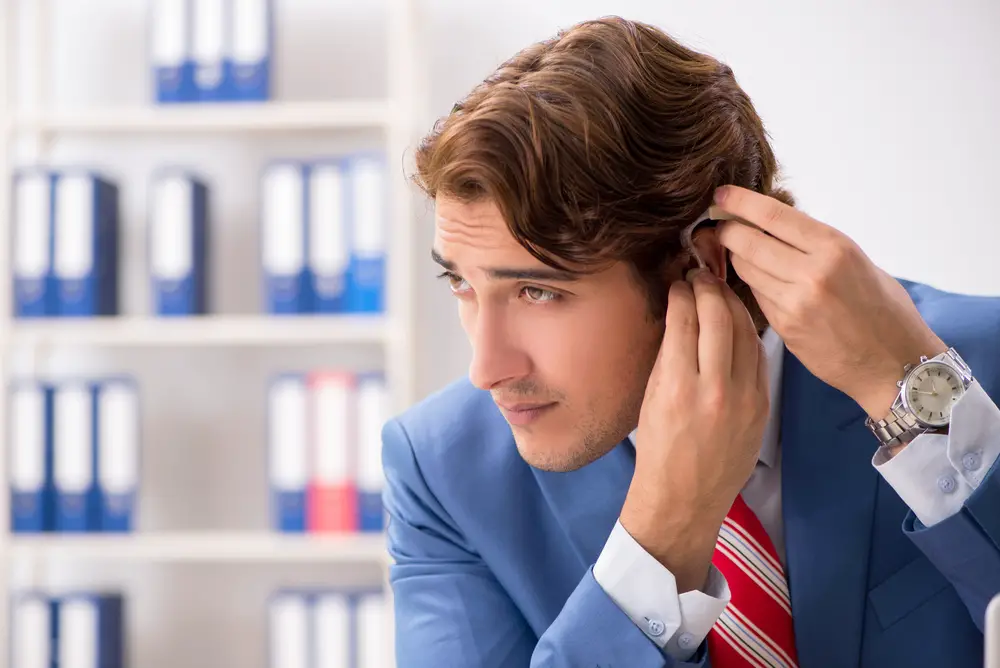 Deaf employee using hearing aid in office