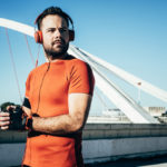 Man playing sports and listening to music with headphones