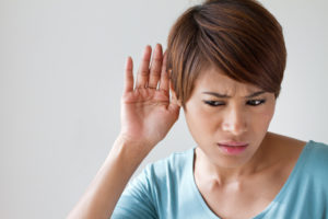 woman suffers from hearing impairment, hard of hearing, hearing loss, acoustic or ear problem, deafness with text space
